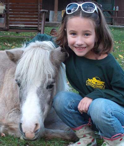 Girl with donkey at Happy Trails Animal Sanctuary