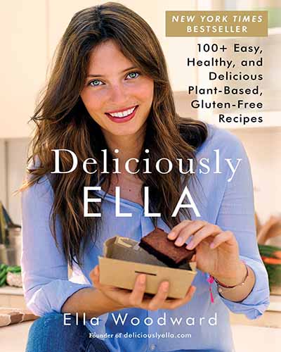 Cover for the book Deliciously Ella. Features a picture of Ella standing in a kitchen while eating a vegan treat.