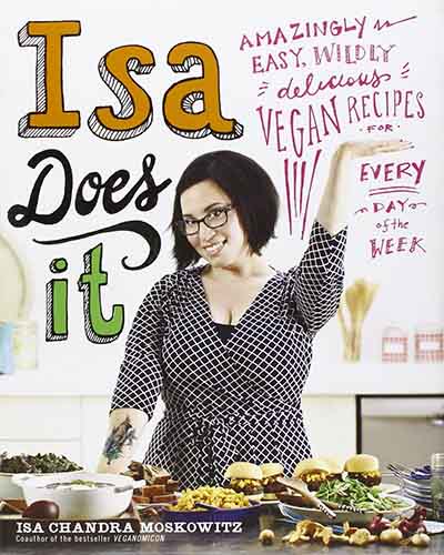 Cover for the book Isa Does It. Features a picture of the author and chef standing in a kitchen in front of a variety of dishes.
