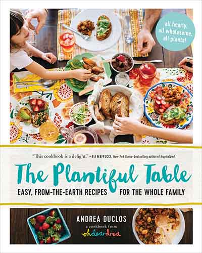 White cover with colorful photos of various meals with The Plantiful Table written in teal over top.