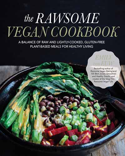 Cover for the book The Rawsome Vegan Cookbook. Features a colorful array of vegetables in a black bowl sitting on top of a wooden table with a black background.