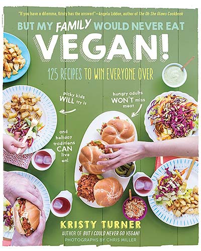 Cover for the book, But My Family Would Never Eat Vegan. Features an overhead photo of a variety of cooked foods with a green background.