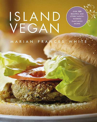 Cover for the book, Island Vegan. Features a close up of a veggie burger on a bun with lettuce.