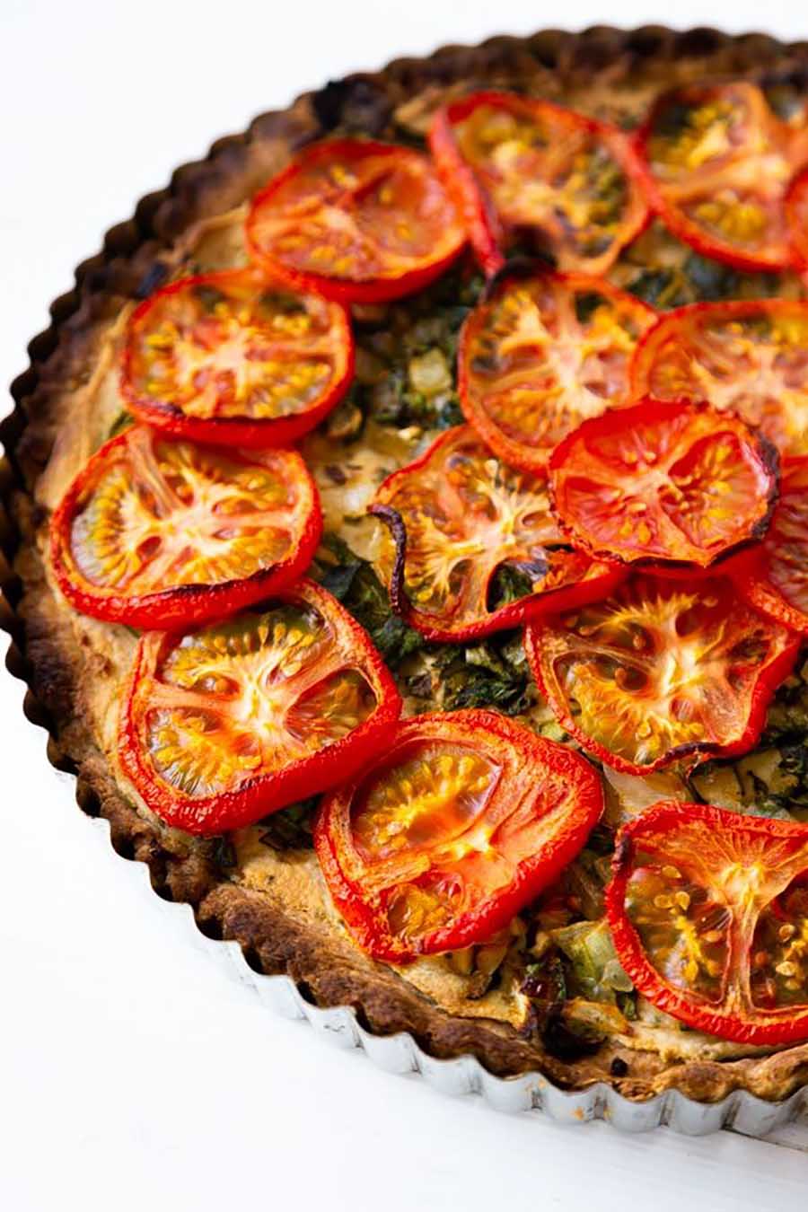 Closeup of a tomato and spinach tart.