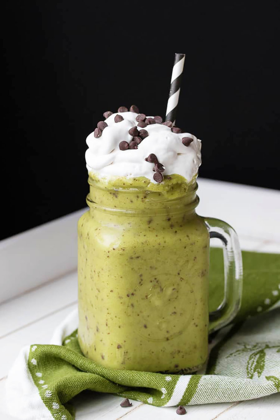 Large shamrock chip shake in a glass mug with whipped topping and a straw